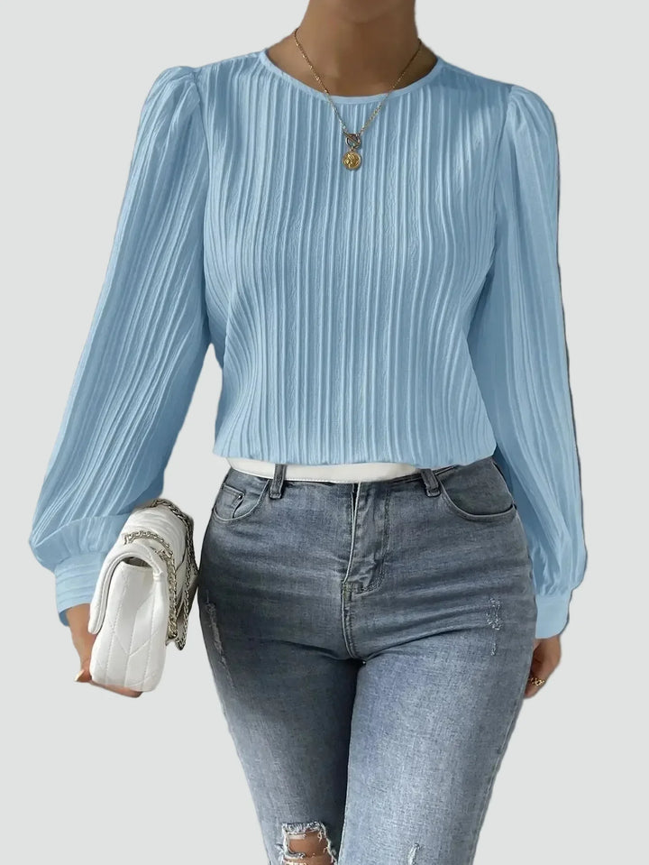 Elegant women's blouse with pleated fabric and puff sleeves