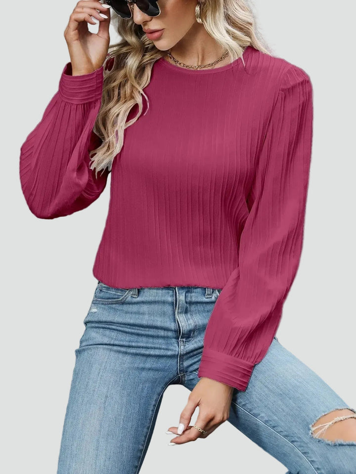 Elegant women's blouse with pleated fabric and puff sleeves