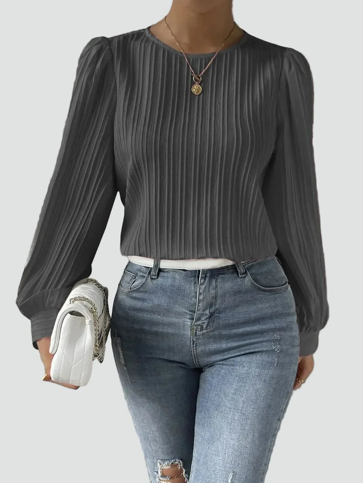 Elegant women's blouse with pleated fabric and puff sleeves