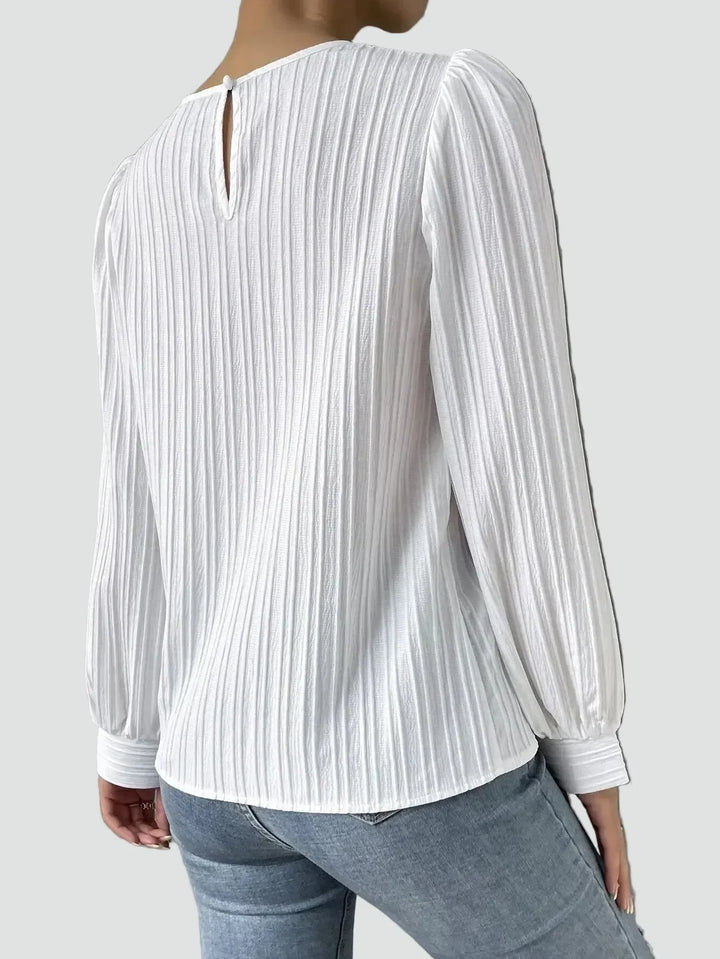Elegant women's blouse with pleated fabric and puff sleeves