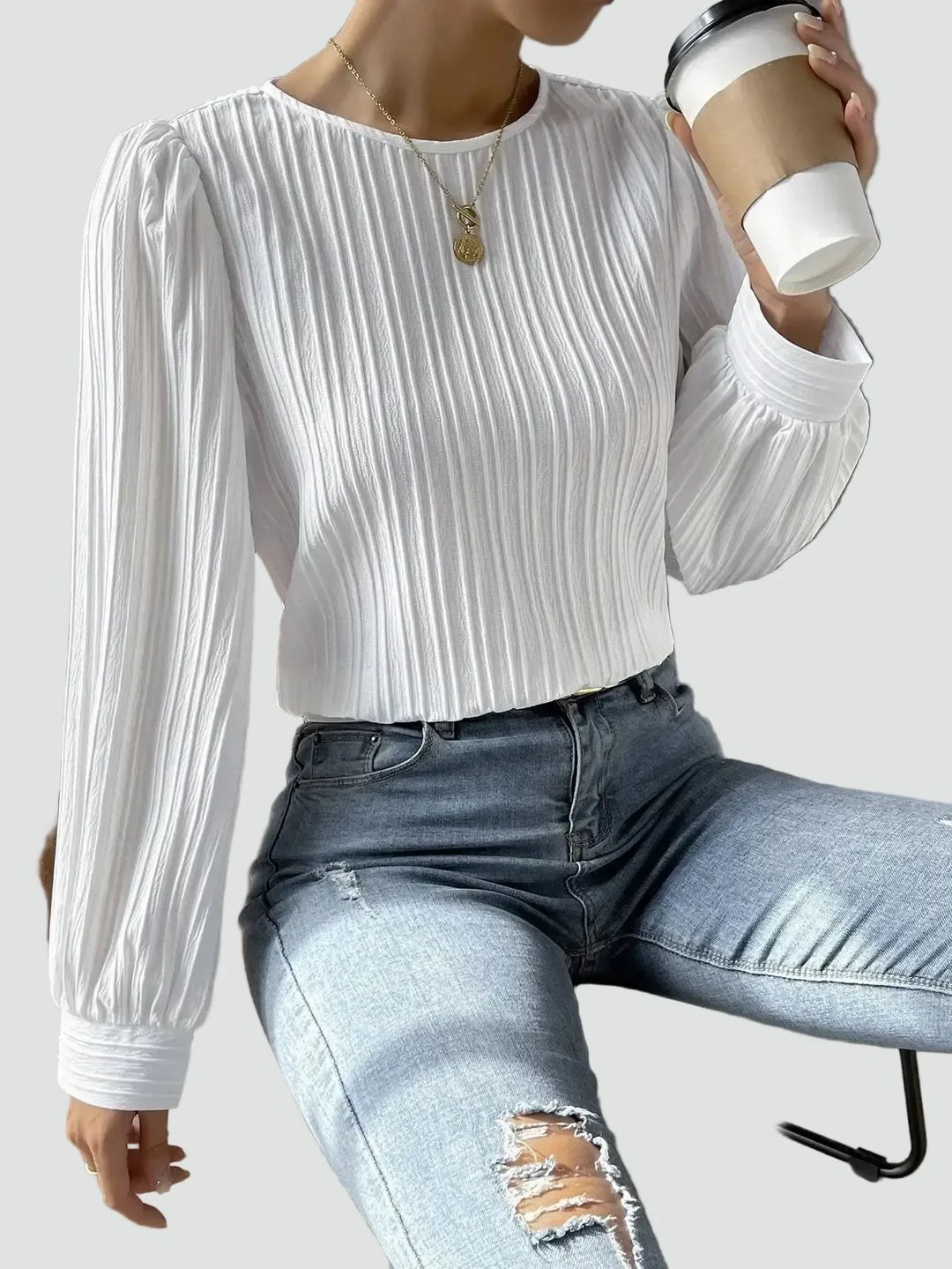 Elegant women's blouse with pleated fabric and puff sleeves