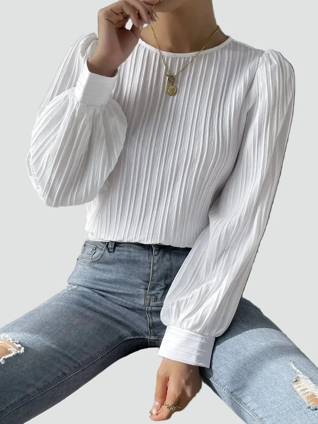 Elegant women's blouse with pleated fabric and puff sleeves